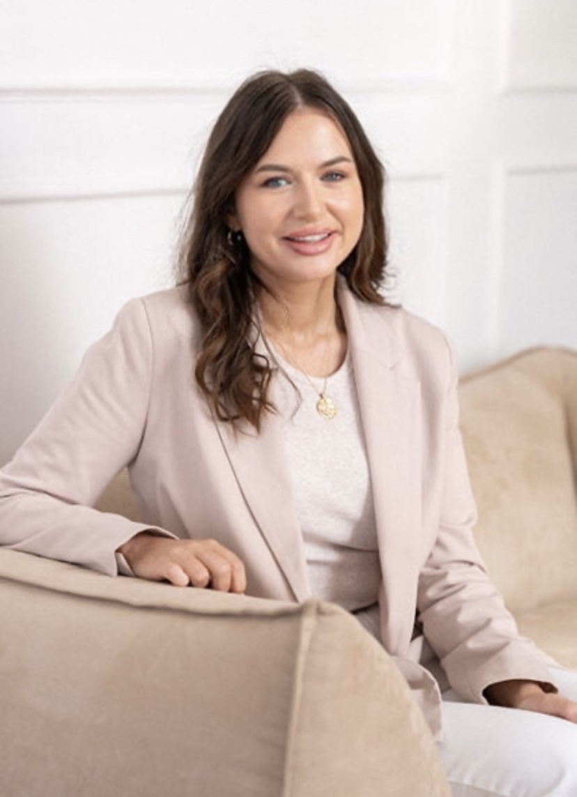 A woman sitting on a beige couch at Matchsticks Marketing Agency.