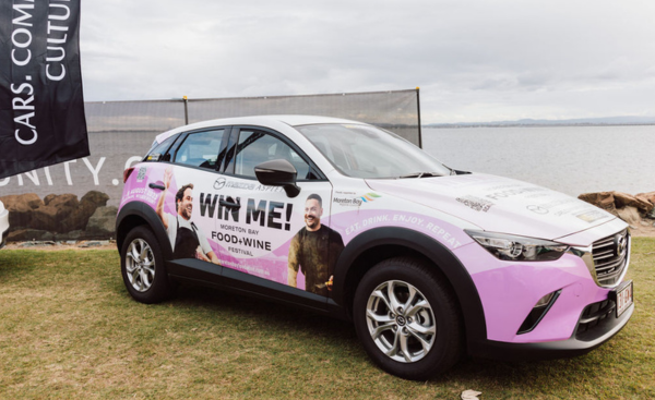 A pink and white Mazda from Aspley Mazda parked at the Moreton Bay Food and Wine Festival.