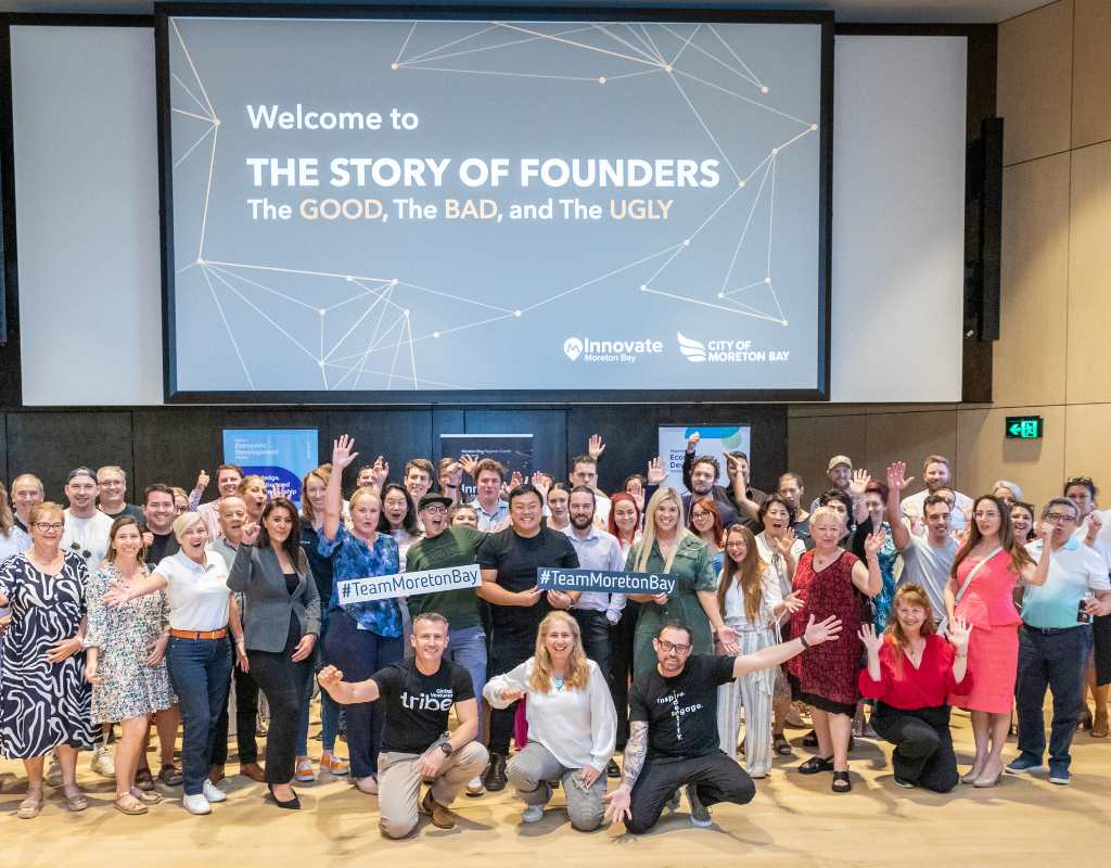 A group of people posing at an Innovate Moreton Bay event showcasing the Story of Founders.